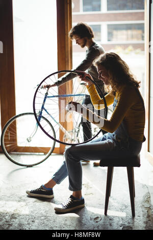 Mechanics examining a bicycle wheel Stock Photo