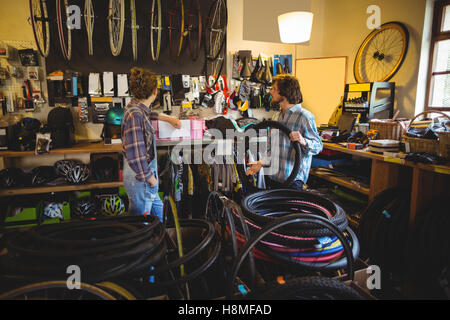 Mechanics selecting tyres Stock Photo