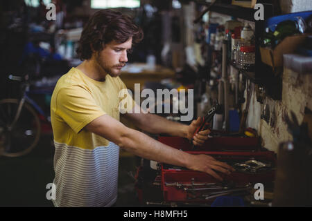 Mechanic selecting tools from toolbox Stock Photo