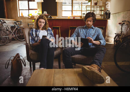 Mechanics using digital tablet and mobile phone Stock Photo