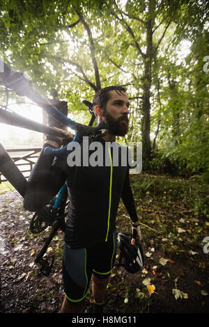 Athlete carrying a bicycle Stock Photo