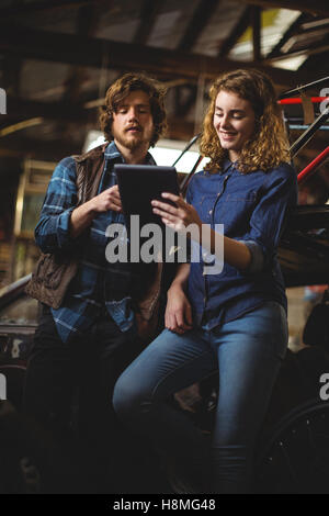 Mechanics using digital tablet Stock Photo