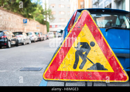 Road signs in a street under reconstruction symbol. Stock Photo
