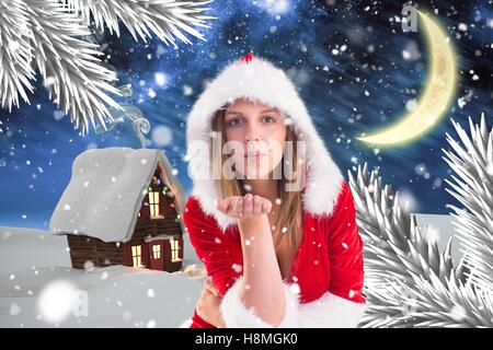 Beautiful woman in santa costume blowing a kiss Stock Photo