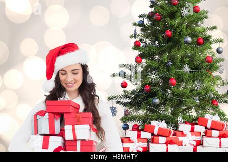 Beautiful woman in santa costume looking at christmas gifts Stock Photo