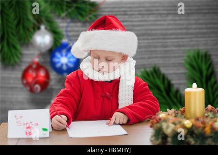 Boy in santa hat writing a letter Stock Photo