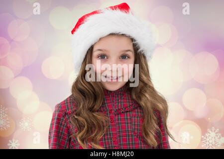 Portrait of girl in santa hat smiling at camera Stock Photo