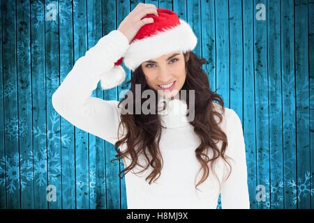 Beautiful woman in santa hat smiling at camera Stock Photo