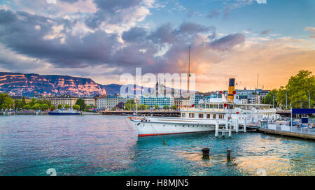 Classic view of the historic city center of Geneva with traditional paddle steamer boat on Lake Geneva at sunset, Switzerland Stock Photo