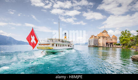 Traditional paddle steamer excursion ship with famous Chateau de Chillon at Lake Geneva in summer, Canton of Vaud, Switzerland Stock Photo