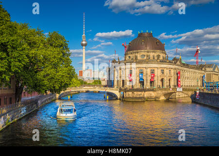 Classic view of Berlin Museum Island with famous TV tower and excursion boat on Spree river in beautiful evening light at sunset Stock Photo