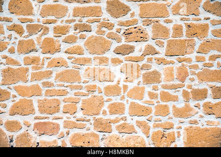 Background from a brown sandstone wall Stock Photo