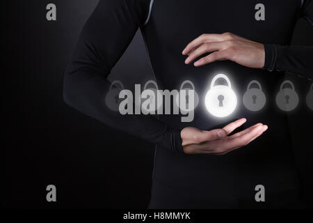 Technology, Internet and network futuristic security concept. Man holding virtual security lock Stock Photo