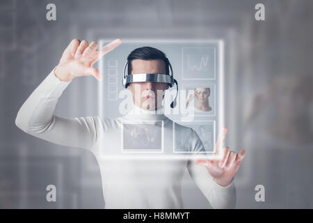 Young man working with modern virtual technology display Stock Photo