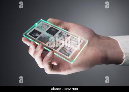 Futuristic smartphone with a transparent display in human hand, Concept actual future innovative ideas Stock Photo