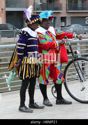 AALST, BELGIUM, NOVEMBER 5 2016: Two colorfully dressed 'Zwarte Piets' (Black Peters) during the arrival of Saint Martin. Stock Photo