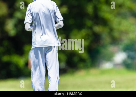 Cricket game teenagers high schools closeup unidentified abstract fielder batsman action. Stock Photo