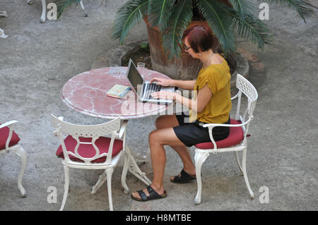 A woman working in a hotel garden in Palma, Majorca Stock Photo