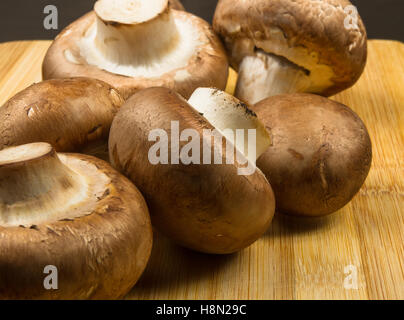 large Royal mushroom champignons on a wooden cutting Board Stock Photo