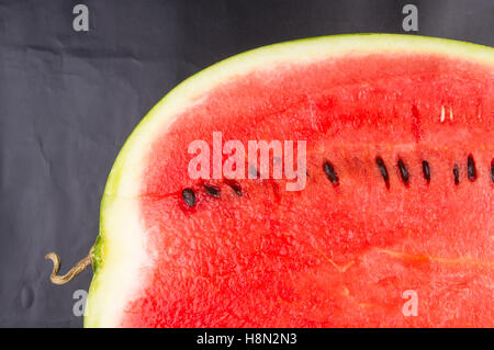 half of ripe watermelon on a black background Stock Photo