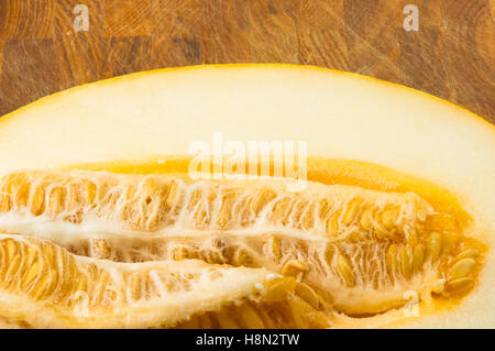 half of ripe juicy melon on wooden background Stock Photo
