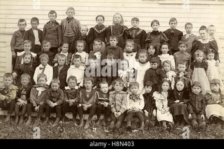 Antique c1890 photograph, school children in Ayer, Massachusetts, USA. A group of 49 students, ages about 5-10 with a teacher at the right. SOURCE: ORIGINAL CABINET CARD PHOTOGRAPH. Stock Photo