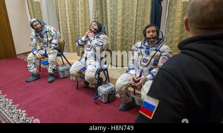 NASA International Space Station Expedition 50 backup crew members Italian astronaut Paolo Nespoli of the European Space Agency, Russian cosmonaut Fyodor Yurchikhin of Roscosmos, and American astronaut Jack Fischer put on their Sokol launch and entry spacesuits before the Soyuz qualification exams at the Gagarin Cosmonaut Training Center October 24, 2016 in Star City, Russia. Stock Photo