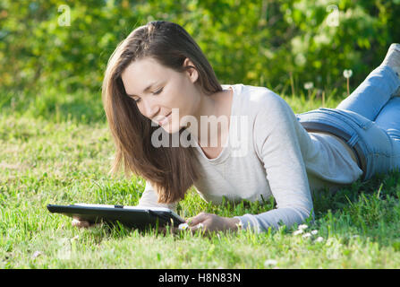 Young woman with tablet pc outdoors Stock Photo