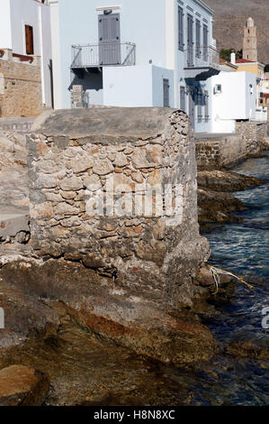 Old disused outside toilet, emptying straight into the harbour, Chalki Island near Rhodes, Dodecanese Islands, Greece. Stock Photo