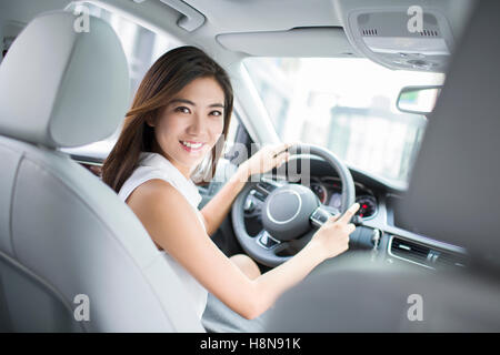 Confident Chinese businesswoman driving car Stock Photo