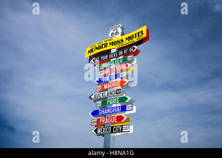 Funny direction signpost at the Munger Moss Motel with names of famous cities worldwide Stock Photo