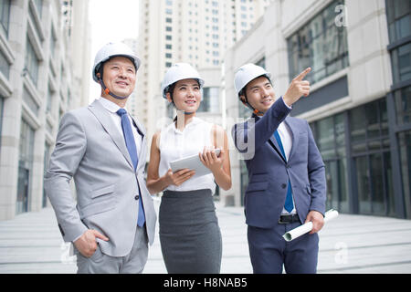 Confident Chinese architects talking outdoors Stock Photo