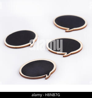 black handcrafted wooden blank speech bubbles with round shape on white background Stock Photo