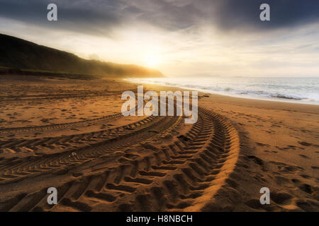 tire tracks prints in the beach sand Stock Photo