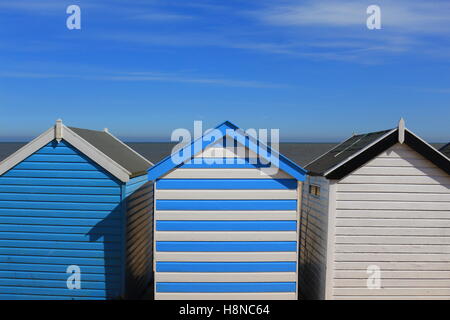 A row of three beach huts on a sunny summer day at Southwold, Suffolk Stock Photo