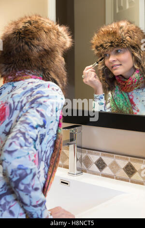 woman putting on her makeup Stock Photo