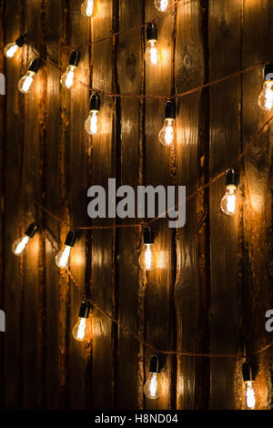 Designer light bulbs on dark wooden background Stock Photo