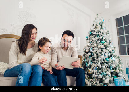 Family playing video game on tablet pc Stock Photo