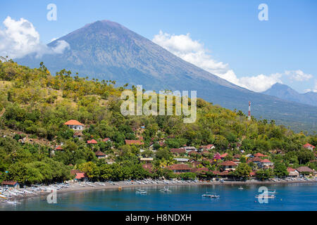 Jemeluk Beach and beautiful blue lagoon with Gunung Agung volcano on background. Amed village, East of Bali, Indonesia. Stock Photo