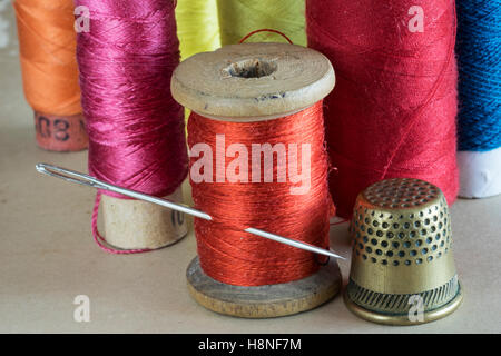 threads for sewing with needle and thimble Stock Photo