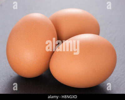 three eggs on slate gray background Stock Photo
