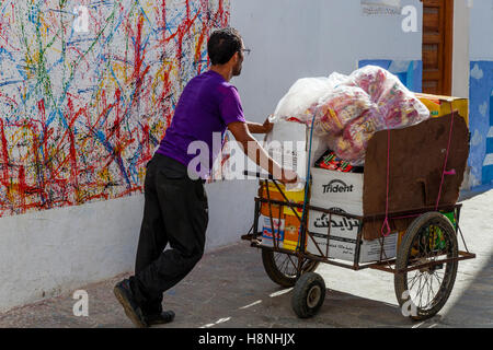 A Young Man Making Deliveries In The Medina, Asilah, Morocco Stock Photo