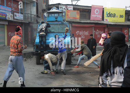 Srinagar, India. 14th Nov, 2016. Protesters attack an Indian paramilitary vehicle after a 16 year old youth, Rizwan Mir, who was injured during a road accident by an Indian paramilitary vehicle a week ago, succumbed in a city hospital at Srinagar in Indian Administered Kashmir. Credit:  Umer Asif/Pacific Press/Alamy Live News Stock Photo