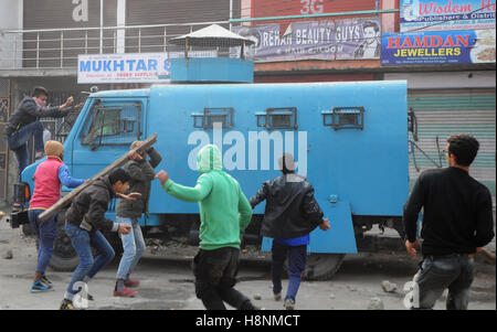 Srinagar, India. 14th Nov, 2016. Protesters attack an Indian paramilitary vehicle after a 16 year old youth, Rizwan Mir, who was injured during a road accident by an Indian paramilitary vehicle a week ago, succumbed in a city hospital at Srinagar in Indian Administered Kashmir. Credit:  Umer Asif/Pacific Press/Alamy Live News Stock Photo