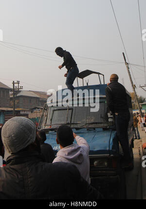 Srinagar, India. 14th Nov, 2016. Protesters attack an Indian paramilitary vehicle after a 16 year old youth, Rizwan Mir, who was injured during a road accident by an Indian paramilitary vehicle a week ago, succumbed in a city hospital at Srinagar in Indian Administered Kashmir. Credit:  Umer Asif/Pacific Press/Alamy Live News Stock Photo