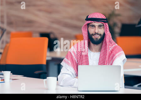 Arabian businessman working in modern startup office Stock Photo