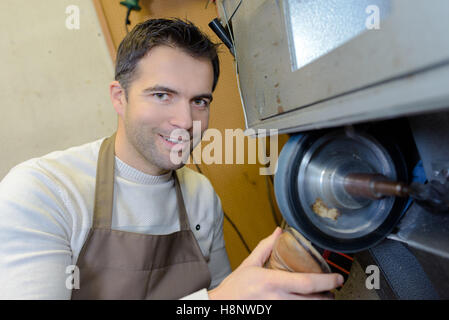 the shoemaker repairs a woman shoe Stock Photo
