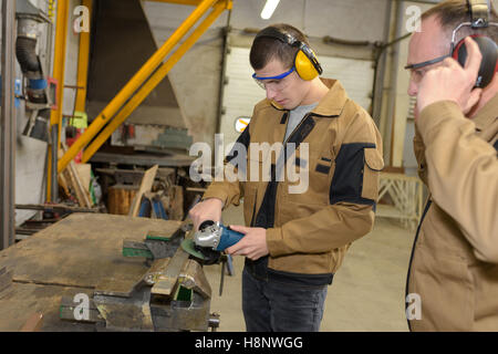 vertical image of man working in joinery polishing up wood Stock Photo