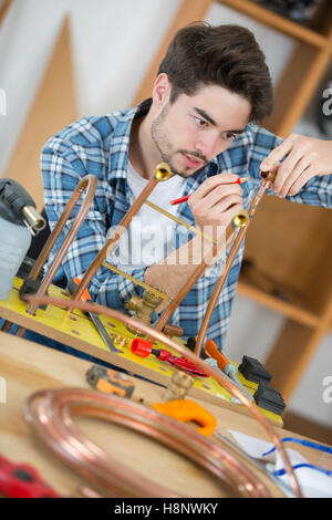 carpenter working on his craft in a dusty workshop Stock Photo