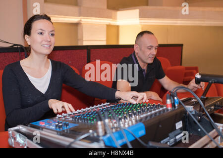 sound engineer and producer working together at mixing panel Stock Photo